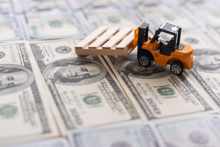 one hundred dollar bills and a toy excavator