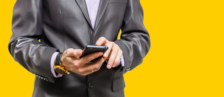 Young cheerful brunete lawyer is standing on the pure light yellow, orange, background