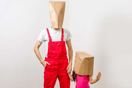man and little girl with packages on their headsの写真素材