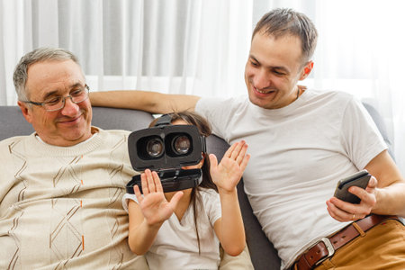 grandfather and granddaughter with virtual glasses