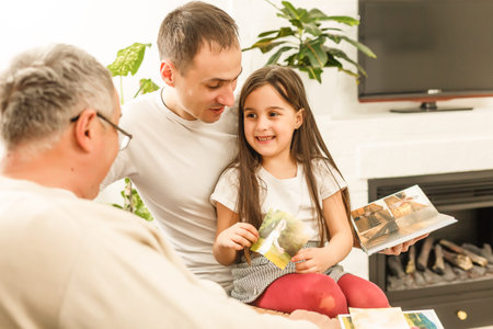 Family looking at a photo album in the living room