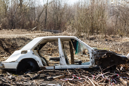 Broken car in a dump in the field