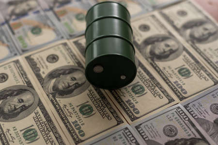 the barrel of oil of one hundred US dollar billsの写真素材