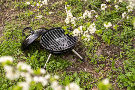 An empty barbecue grill stands in the yardの写真素材