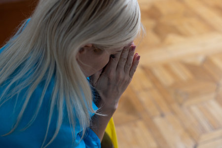 blonde woman wrapped in Ukraine flag. Support for Ukraine concept