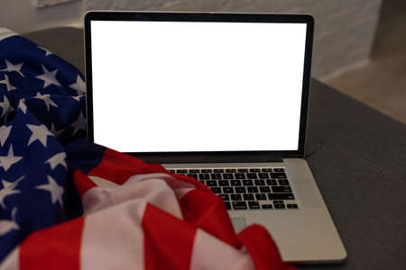 Laptop with blank screen and USA flagの写真素材