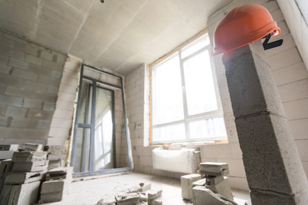 Break the wall for renovation and build the door for entrance of building. Wheelbarrow with broken...