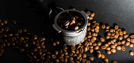 Coffee beans in the coffee horn on the background of coffee beansの写真素材
