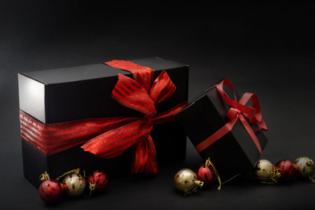 gift with a red ribbon. Black gift box