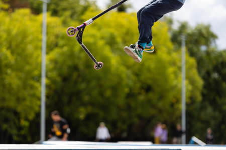 child going airborne with his scooterの写真素材