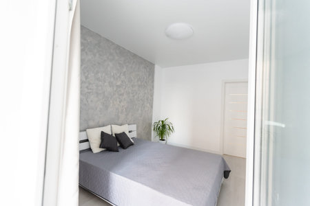 Gray bed and bright sunshine