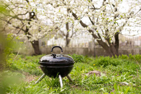 An empty barbecue grill stands in the yardの写真素材