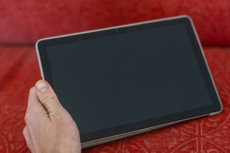 digital tablet on an old couchの写真素材