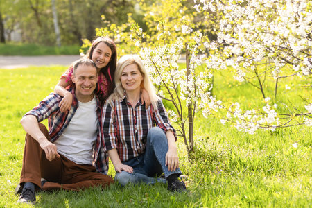 Happy young family spending time together outside in green nature