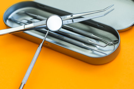Dentist tools. Teethcare, dental health concept. orange background top view copy spaceの写真素材