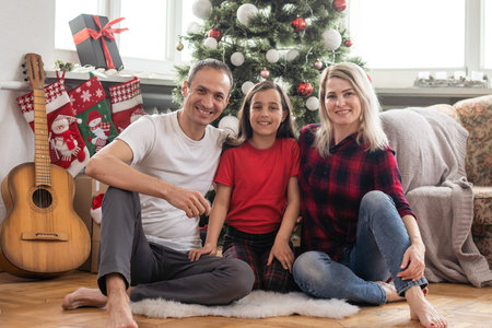 Christmas family. Happy mom, dad and little daughter. Enjoyng love hugs, holidays people....