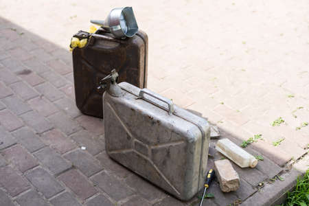 canister and watering can for diesel. the canister with the fuel and the filler funnel.の写真素材