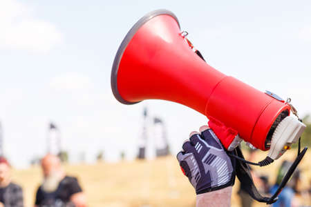 man standing screaming with mouthpiece.の写真素材