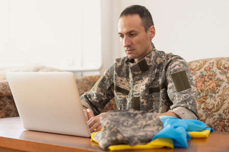 Message for world peace. military with laptop and flag of ukraineの写真素材