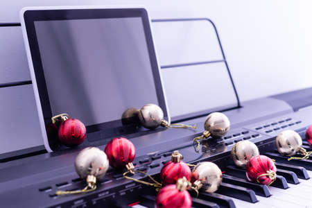 Piano keyboard with Christmas garland close upの写真素材