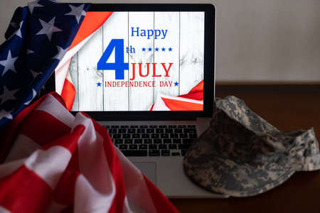 American flags with inscription Happy Independence Day on laptopの写真素材