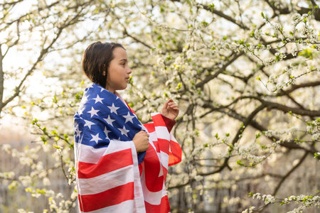 July 4th: Excited Little Girl Holding Flagsの写真素材