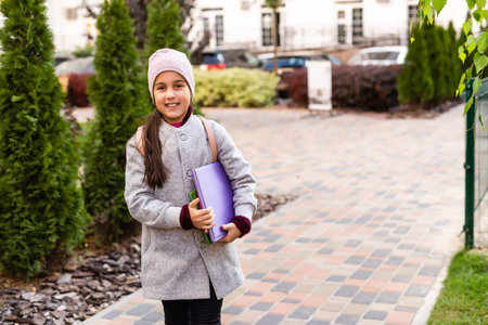 Beautiful young elementary school girl autumn