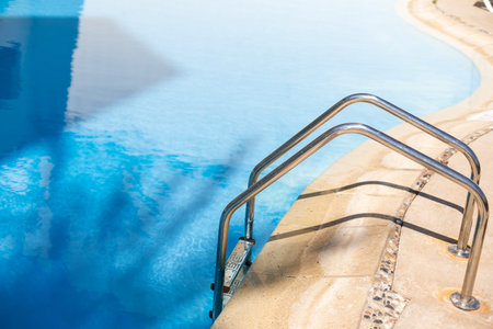 Stair around outdoor swimming pool in hotel resort for travel vacation.