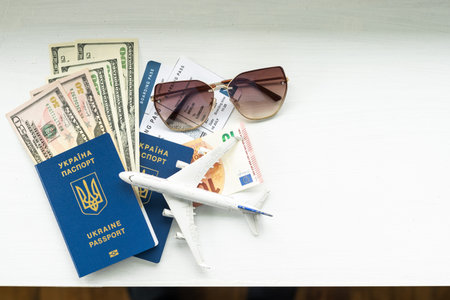 Passport of a citizen of Ukraine and a toy plane on a white background. Inscription in Ukrainian...