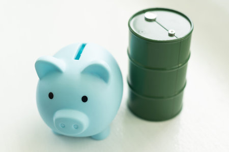 pig piggy bank and tin barrel of fuel
