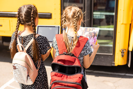 Back to school. First day of school. Two teenage girs at the school feeling happy and excited.