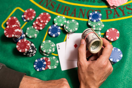 Happy poker player winning and holding cards.