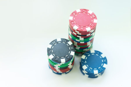 Plastic casino chips stacked on white background. Poker game