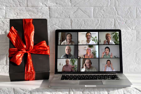 Family online video conference, christmas greetings. Virtual call through screen of laptopの写真素材