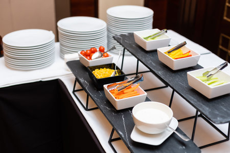 The salad buffet bar at the restaurant with lots of vegetables dishes.
