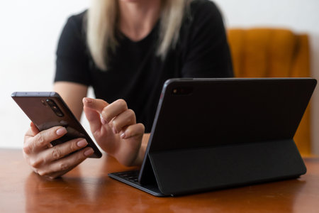 Lets check my timetable. Cheerful young beautiful woman using her touchpad with smile while sitting...