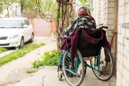 Old woman sitting in a wheelchair looking sad and worried. depression, healthcare and caring for the elderlyの写真素材
