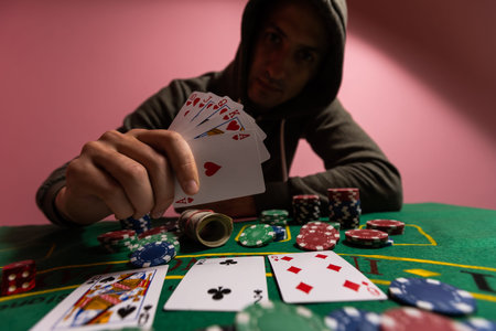 Happy poker player winning and holding cards.
