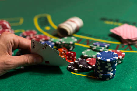 Casino, gambling and entertainment concept - stack of poker chips on a green table.の写真素材