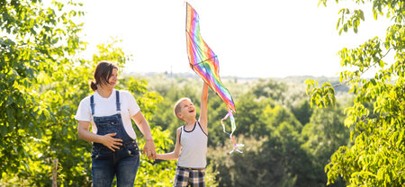 pregnant woman with her son playing a kiteの写真素材