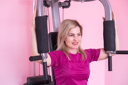 Tired young woman doing exercise at home. Fitness and weight loss concept