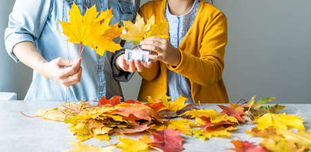Happy family doing autumn decor. Fall atmosphereの写真素材
