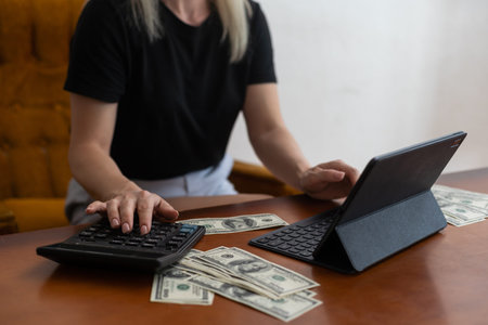 Woman counting money, US dollars