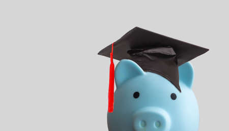 Piggy bank with graduation cap, Business finance education saving money scholarship concept.の写真素材