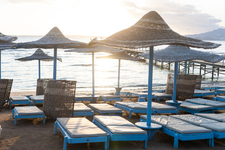 Straw beach rattan umbrellas at the beachの写真素材