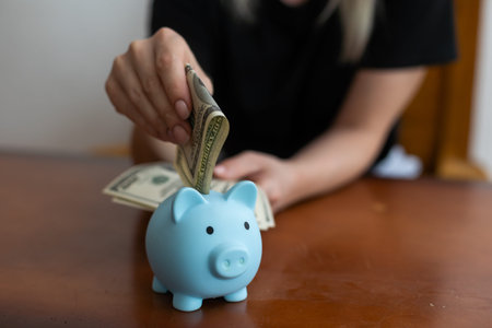 a woman keeps money in a piggy bank