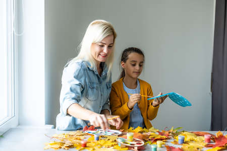 Happy family doing autumn decor. Fall atmosphereの写真素材