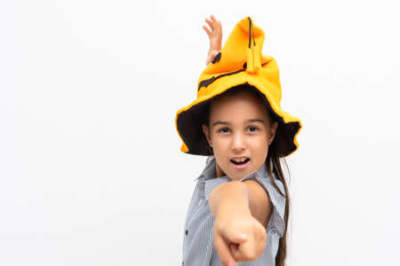 little girl in a witch hat on a white backgroundの写真素材
