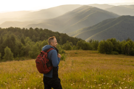 Man traveling with backpack hiking in mountains Travel Lifestyle success concept adventure active...