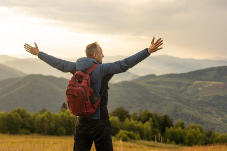 Young man enjoying the view on the top of the mountain. Carpathian mountains, Ukraineの写真素材